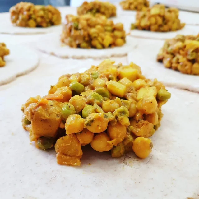 Curried Chickpea handpies are a staple in our lineup! 

Filled with protein-packed goodness and mild coconut milk yellow curry flavour, this vegetarian favourite is in the hot service cabinet today. 

We're baking up Strawberry Rhubarb sweet pies too, so I already know what's for lunch 🤩